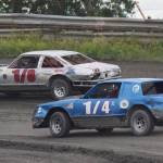 Chris Endsley (1/8) holds off Damian LaMountain (1/4) in the A-Stock feature race Saturday night at Twin City Raceway in Kenai. (Photo by Joey Klecka/Peninsula Clarion)