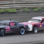 Sean Endsley (right) puts the bumper to Gracie Bass (16) in an A-Stock heat race Saturday night at Twin City Raceway in Kenai. (Photo by Joey Klecka/Peninsula Clarion)