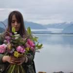 Florist Melissa Garcia Johnson arranges wildflowers at a beach near North Douglas Highway on Wednesday. (Photo by Kevin Gullufsen/Juneau Empire)