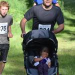 Jake Streich pushes the family stroller Saturday morning in the 10-kilometer race at the Soldotna Rotary Run at the Tsalteshi Trails. (Photo by Joey Klecka/Peninsula Clarion)