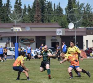 Kenai Wolfpack and Fairbanks SunDawgs players compete in a loser-out semifinal Saturday at the Between the Tides Dipfest Rugby 10s tournament at Spur View field in Kenai. (Photo by Joey Klecka/Peninsula Clarion)