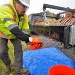 Kenai Parks and Recreation employee Jacob Hart removes nails he picked up from Kenais south beach with a magnetic bar mounted behind a tractor rake on Friday, July 20, 2018. Hart has been sweeping the beachs each evening since the July 10 start of the dipnet fishery, using the magnet rake to concentrate on areas where pallet bonfires have occurred. As of Friday, he estimated hes picked up about 15 pounds of metal debris. (Ben Boettger/Peninsula Clarion).