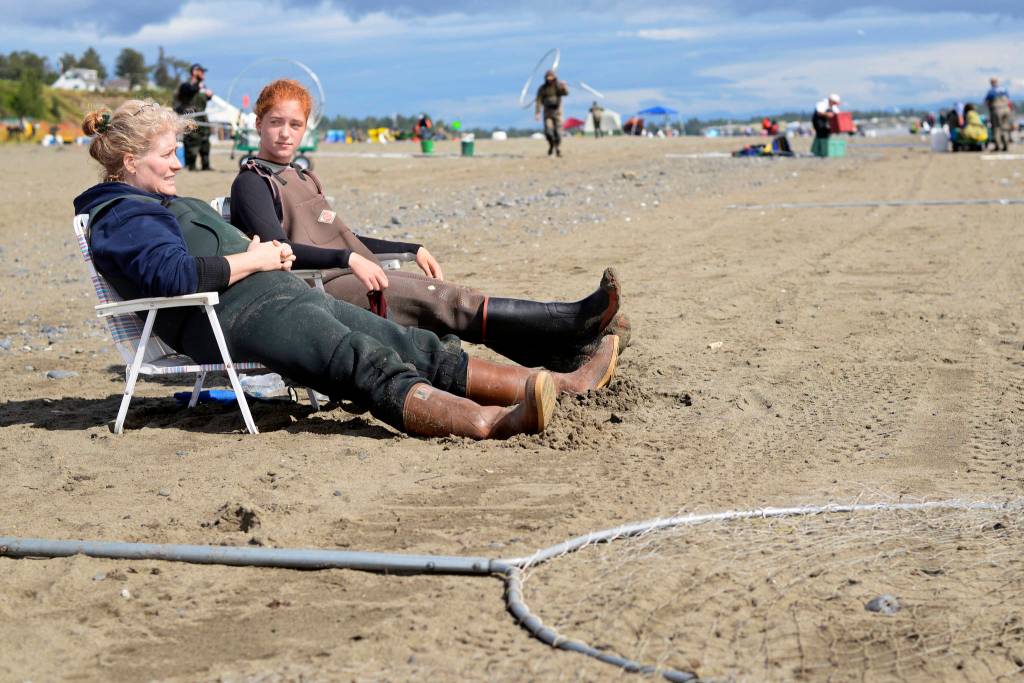 Tiffany Musgrave (left) and daughter McCady Musgrave take a break from dipnetting on Kenais north beach on Thursday in Kenai. Tiffany Musgrave said the family had caught two salmon that day and four the previous day, making this years dipnet one of the worst she remembered  one year, she recalled, she and her husband had caught 64 fish in four hours on Kenais south beach. (Ben Boettger/Peninsula Clarion)