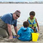 Dipnetter Brad Gamblin (left) digs in the sand of Kenais north beach with his grandchildren Stella (in blue) and Marly Wilson, on Thursday in Kenai. The three, plus grandmother Cher Gamblin, brought the grandchildren on their first dipnetting trip this year. The morning, Brad Gamblin said, was very productive. Getting up early, he said the family had caught a dozen salmon by 9 a.m. (Ben Boettger/Peninsula Clarion)