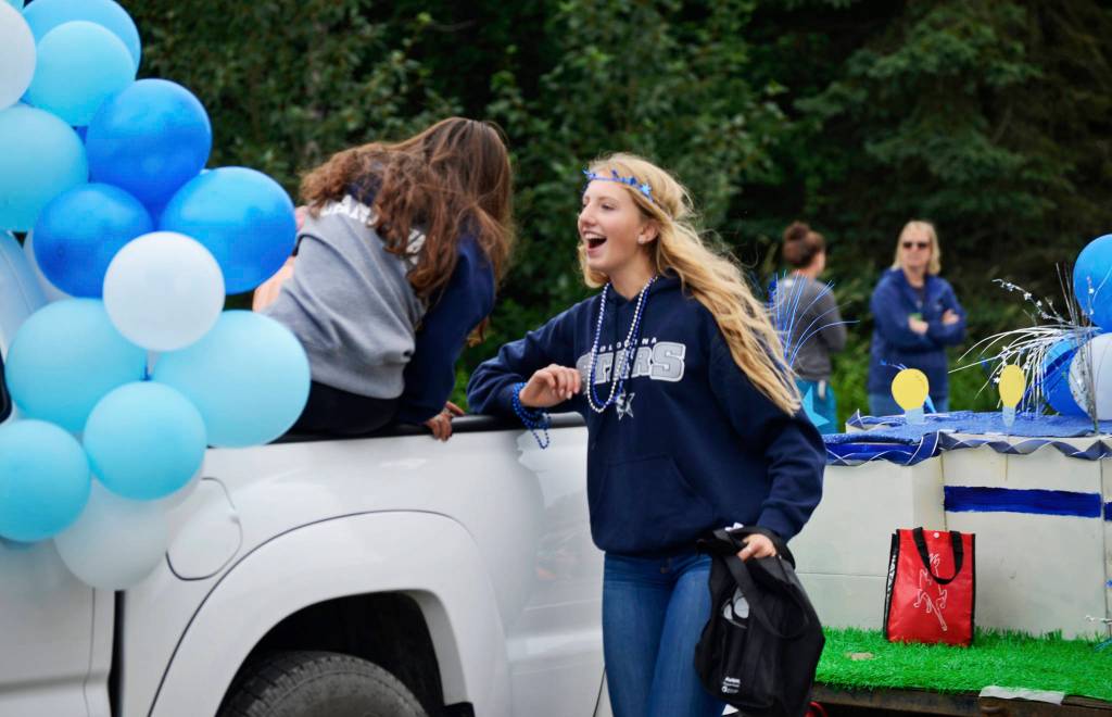 Participants in Soldotna High Schools float in the Progress Days parade chat as they make their way down Marydale Avenue on Saturday, July 28, 2018 in Soldotna, Alaska. The parade kicks off the weekend-long event celebrating Soldotnas history, with a market on Saturday and Sunday in Soldotna Creek Park and a concert Saturday night followed by a free community barbecue Sunday. (Photo by Elizabeth Earl/Peninsula Clarion)