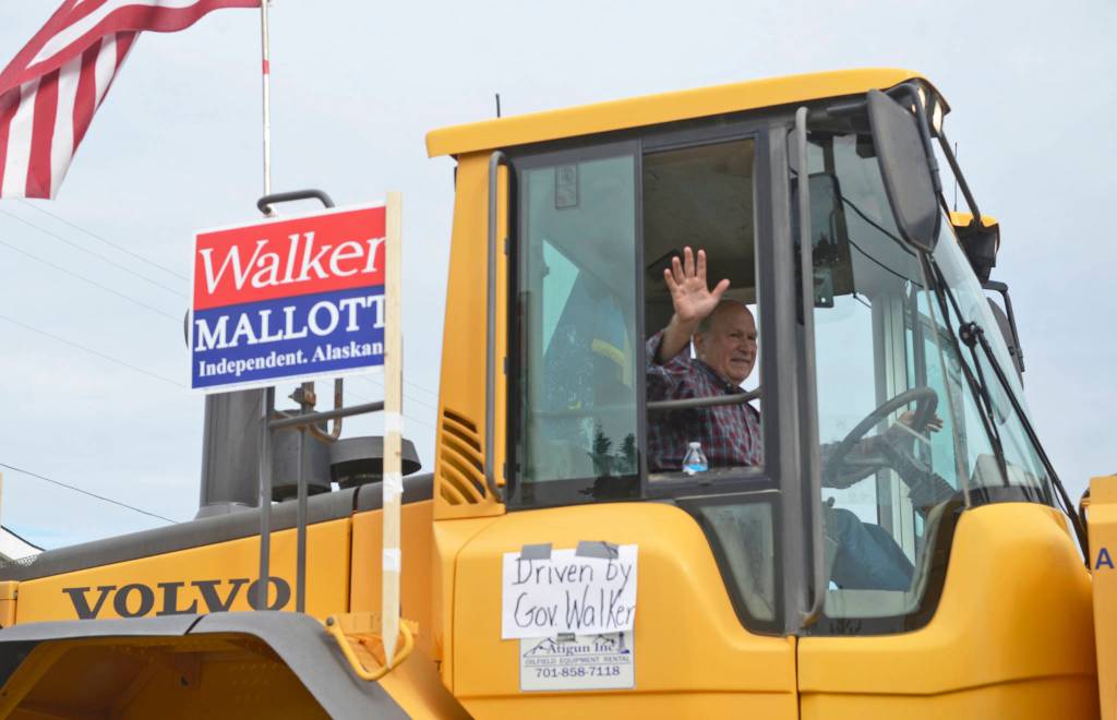 Gov. Bill Walker drives a tractor part of his gubernatorial reelection campaign float in the Progress Days parade down Marydale Avenue on Saturday, July 28, 2018 in Soldotna, Alaska. The parade kicks off the weekend-long event celebrating Soldotnas history, with a market on Saturday and Sunday in Soldotna Creek Park and a concert Saturday night followed by a free community barbecue Sunday. (Photo by Elizabeth Earl/Peninsula Clarion)