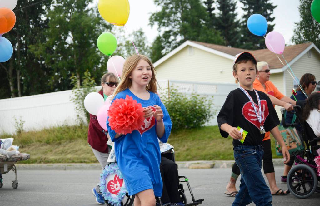 Participants in Heritage Places dispaly in the Progress Days parade chat as they make their way down Marydale Avenue on Saturday, July 28, 2018 in Soldotna, Alaska. The parade kicks off the weekend-long event celebrating Soldotnas history, with a market on Saturday and Sunday in Soldotna Creek Park and a concert Saturday night followed by a free community barbecue Sunday. (Photo by Elizabeth Earl/Peninsula Clarion)