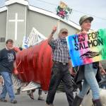 Volunteers in Stand for Salmons float in the Progress Days parade carry a large replica of a sockeye salmon down Marydale Avenue on Saturday, July 28, 2018 in Soldotna, Alaska. The parade kicks off the weekend-long event celebrating Soldotnas history, with a market on Saturday and Sunday in Soldotna Creek Park and a concert Saturday night followed by a free community barbecue Sunday. (Photo by Elizabeth Earl/Peninsula Clarion)