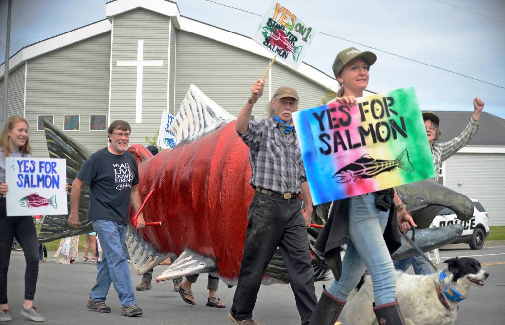 Volunteers in Stand for Salmons float in the Progress Days parade carry a large replica of a sockeye salmon down Marydale Avenue on Saturday, July 28, 2018 in Soldotna, Alaska. The parade kicks off the weekend-long event celebrating Soldotnas history, with a market on Saturday and Sunday in Soldotna Creek Park and a concert Saturday night followed by a free community barbecue Sunday. (Photo by Elizabeth Earl/Peninsula Clarion)