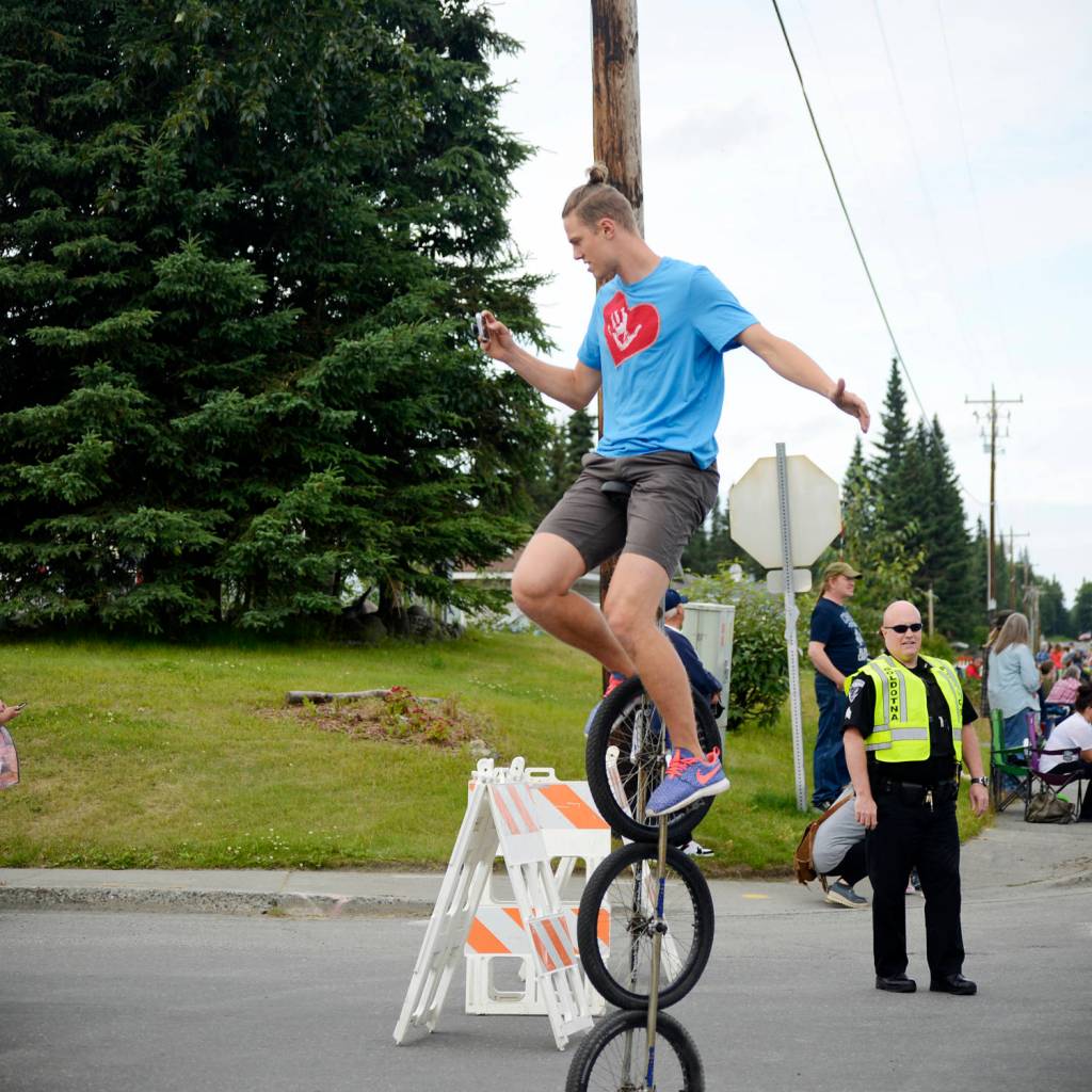 Josiah Martin of Soldotna deftly perches atop a unicycle during the Progress Days parade on Saturday, July 28, 2018 in Soldotna, Alaska. The parade kicks off the weekend-long event celebrating Soldotnas history, with a market on Saturday and Sunday in Soldotna Creek Park and a concert Saturday night followed by a free community barbecue Sunday. (Photo by Elizabeth Earl/Peninsula Clarion)