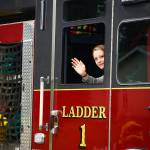 A participant in Central Emergency Services float in the Progress Days parade waves to spectators on Saturday, July 28, 2018 in Soldotna, Alaska. The parade kicks off the weekend-long event celebrating Soldotnas history, with a market on Saturday and Sunday in Soldotna Creek Park and a concert Saturday night followed by a free community barbecue Sunday. (Photo by Elizabeth Earl/Peninsula Clarion)
