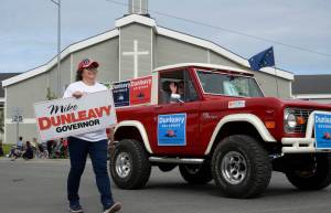 Volunteers for gubernatorial candidate Mike Dunleavys float in the Progress Days parade make their way down Marydale Avenue on Saturday, July 28, 2018 in Soldotna, Alaska. The parade kicks off the weekend-long event celebrating Soldotnas history, with a market on Saturday and Sunday in Soldotna Creek Park and a concert Saturday night followed by a free community barbecue Sunday. (Photo by Elizabeth Earl/Peninsula Clarion)