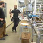 Peninsula Clarion file photo Chris Buerge and Kelly Hagelund, employees of Midnight Sun Electric, discuss the particulars of one of the hands-on labs being built in the new Career and Technical Education Center at the Kenai Peninsula College Kenai River Campus Sept. 3, 2013. The new facility provides hands-on technical education for students.