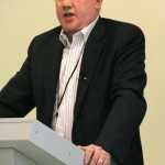 Andy Keleman, vice president of supply managment for Agrium, speaks about the company's desire to reopen its Nikiski plant at the 2014 Kenai Industry Update Forum at the Challenger Learning Center of Alaska in Kenai on Jan. 30, 2014.