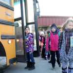 Mountain View Elementary School students start boarding the bus Wednesday afternoon in Kenai. Teachers joined the students for the end-of-the-school-day routes. Photo by Kaylee Osowski/Peninsula Clarion
