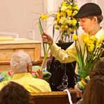 Photo by Rashah McChesney/Peninsula Clarion  Several people passed yellow flowers to audience members Tuesday Feb. 18, 2014 during a memorial for 6-year-old Floyd Murphy at the Soldotna Nazarene Church in Soldotna, Alaska.