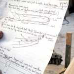 Photo by Rashah McChesney/Peninsula Clarion  Cliff Sisson holds instructions for a portion of a wooden Iditarod sled he and two companions are building in advance of this year's race Thursday Feb. 20, 2014 in Kasilof, Alaska.
