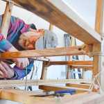 Photo by Rashah McChesney/Peninsula Clarion  Alan Perry works on a wooden Iditarod sled he and two companions are building for this year's race Thursday Feb. 20, 2014 in Kasilof, Alaska.