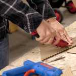 Photo by Rashah McChesney/Peninsula Clarion Chelsea Springer, freshman, cuts a piece of cardboard to add to a piece needed for her sculpture class Wednesday Feb. 26, 2014 at Kenai Peninsula College Kenai River Campus in Soldotna, Alaska. The assignment began with students building a smaller form and transforming it into a larger piece. "It's pretty abstract, but I think it kind of looks like a reclining person. Or an octopus. It's open to interpretation," she said.