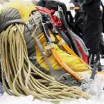 In this Feb. 9, 2014 photo, an ice climber's gear sits beside a log at the bottom of the icefall inside Wildcat Canyon at Starved Rock State Park new Utica, Ill. Climbers pack snacks, water and ropes that are up to 500 feet long. The ropes are made especially for ice climbing, and climbers only use them one time, due to fraying and tension. (AP Photo/NewsTribune, Scott Anderson)