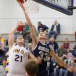 Photo by Rashah McChesney/Peninsula Clarion  Cook Inlet Academy's Riley Smithwick watches Ninilchik's Austin White slap a shot away from the basket during their game Thursday Feb. 27, 2014 in Soldotna, Alaska.