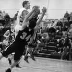 Photo by Rashah McChesney/Peninsula Clarion Cook Inlet Academy's Timmy Smithwick drives to the hoop as Ninilchik's Robert Delgado is charged with a blocking foul Thursday Feb. 27, 2014 in Soldotna, Alaska.