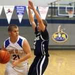 Photo by Rashah McChesney/Peninsula Clarion  Cook Inlet Academy's Riley Smithwick looks for an opening to pass during their game against Ninilchik Thursday Feb. 27, 2014 in Soldotna, Alaska.