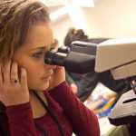 Photo by Rashah McChesney/Peninsula Clarion  Zykiah Cooney, sophomore at Nikiski High School, looks at blood cells under a microscope during a career day event at Central Peninsla Hospital Tuesday Feb. 25, 2014 in Soldotna, Alaska.