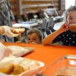 Photo by Rashah McChesney/Peninsula Clarion Kash Bishop, 3, eyeballs a piece of fry bread as Kaydence Monti, 6, digs in during the monthly "Fry Bread Friday" Friday March 7, 2014 at Ft. Kenay in Kenai, Alaska.  Proceeds from the fledgling fundraiser benefit the Holy Assumption of the Virgin Mary Russian Orthodox Church.
