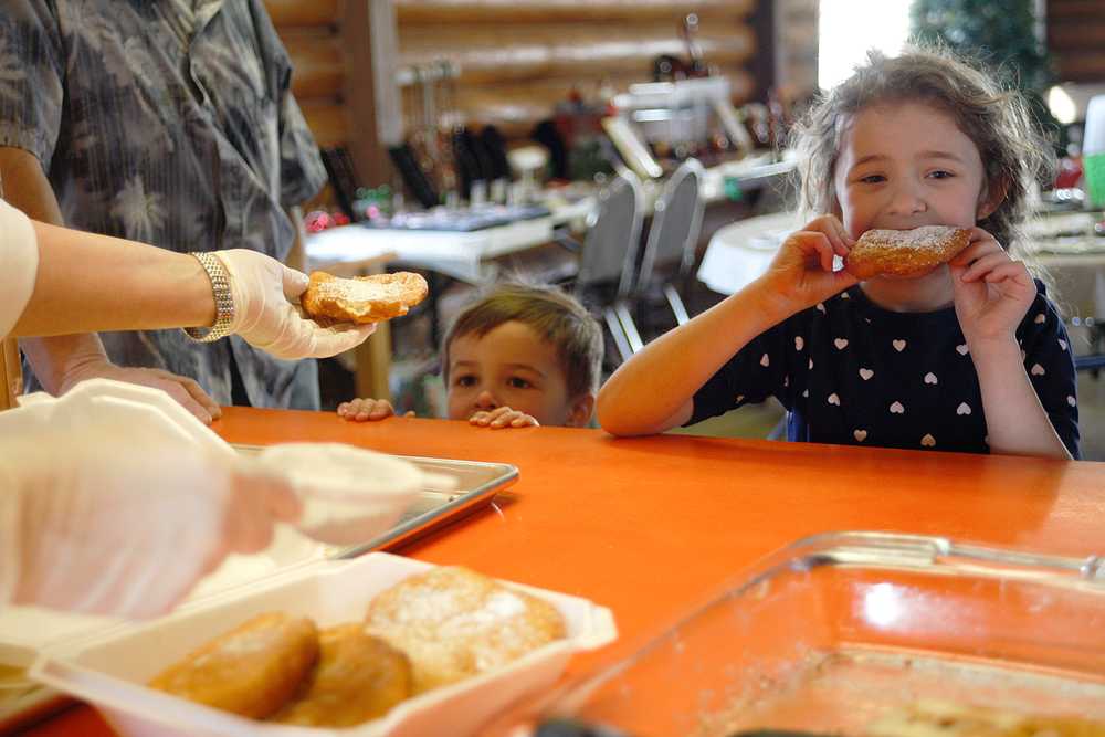 Photo by Rashah McChesney/Peninsula Clarion Kash Bishop, 3, eyeballs a piece of fry bread as Kaydence Monti, 6, digs in during the monthly "Fry Bread Friday" Friday March 7, 2014 at Ft. Kenay in Kenai, Alaska.  Proceeds from the fledgling fundraiser benefit the Holy Assumption of the Virgin Mary Russian Orthodox Church.