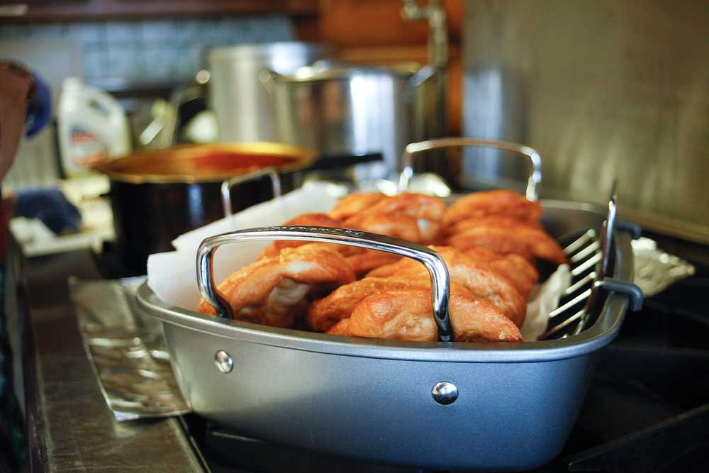 Photo by Rashah McChesney/Peninsula Clarion  A stack of fresh fry bread sits atop a stove Friday March 7, 2014 at Ft. Kenay in Kenai, Alaska. Volunteers said they'll sell 120 pieces of fry bread and another 120 piroshki if they sell out.