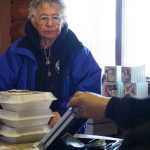 Photo by Rashah McChesney/Peninsula Clarion  Mary Lou Bottorf pays for her treats during "Fry Bread Friday" Friday March 7, 2014 at Ft. Kenay in Kenai, Alaska. Proceeds from the sale benefit the Holy Assumption of the Virgin Mary Russian Orthodox Church in Kenai.