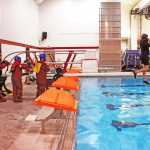 Greg Olcott teaches demonstrates how to safely side step off the side of a large vessel. Photo by Kelly Sullivan/ Peninsula Clarion