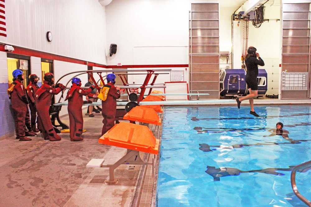 Greg Olcott teaches demonstrates how to safely side step off the side of a large vessel. Photo by Kelly Sullivan/ Peninsula Clarion