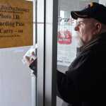 Photo by Rashah McChesney/Peninsula Clarion  Chris Barone, of Missouri, was first in line to leave the Kenai Municipal Airport Saturday March 15, 2014 in Kenai, Alaska. Barone and more than 100 other passengers were stranded in Kenai for 18 hours after their flight was diverted from Anchorage due to inclement weather.