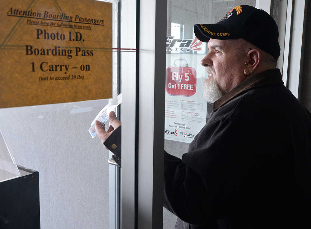 Photo by Rashah McChesney/Peninsula Clarion  Chris Barone, of Missouri, was first in line to leave the Kenai Municipal Airport Saturday March 15, 2014 in Kenai, Alaska. Barone and more than 100 other passengers were stranded in Kenai for 18 hours after their flight was diverted from Anchorage due to inclement weather.