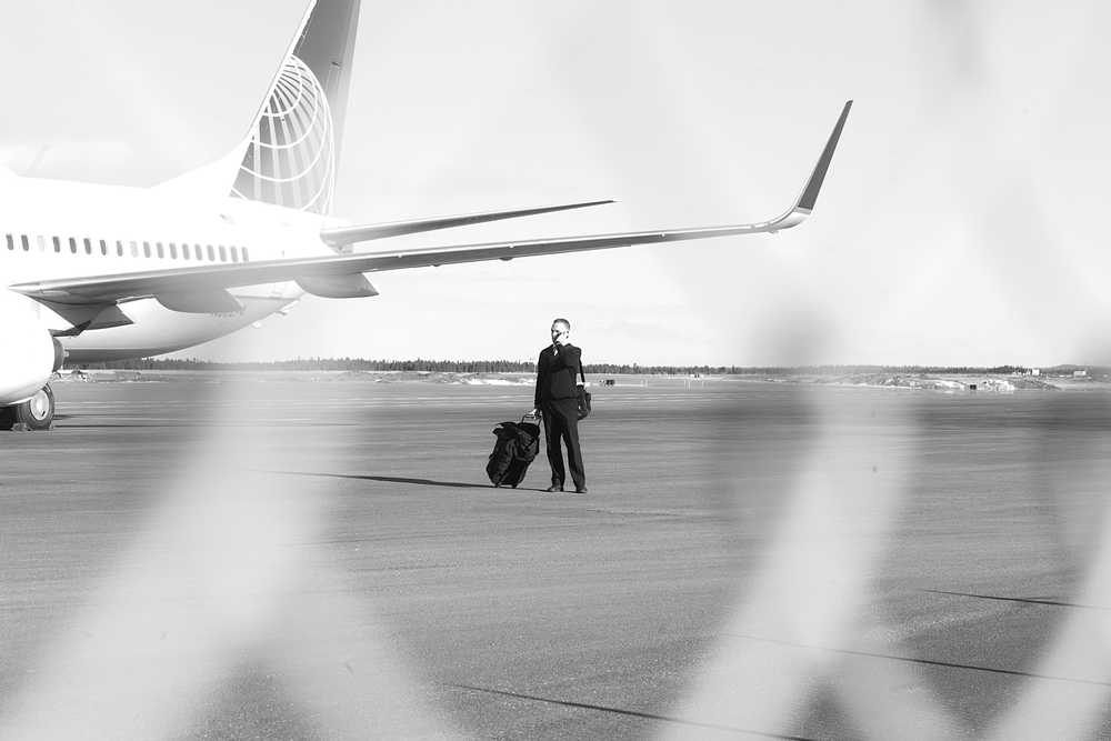 Photo by Rashah McChesney/Peninsula Clarion A member of the United Airlines flight 1425 crew stands on the tarmac about Saturday March 15, 2014 as the plane waited at the Kenai Municipal Airport. Passengers and crew were stranded in Kenai for about 18 hours after their flight was diverted from Anchorage.