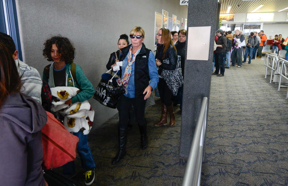 Photo by Rashah McChesney/Peninsula Clarion  About 100 people wait to board a United Airlines flight Saturday March 15, 2014 after the group was stranded for about 18 hours in Kenai, Alaska.