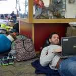 Photo by Rashah McChesney/Peninsula Clarion Andrew Spicher, of New York, messes around on his computer as he and several Alyeska-bound friends wait to leave the Kenai Municipal Airport Saturday March 15, 2014 in Kenai, Alaska.