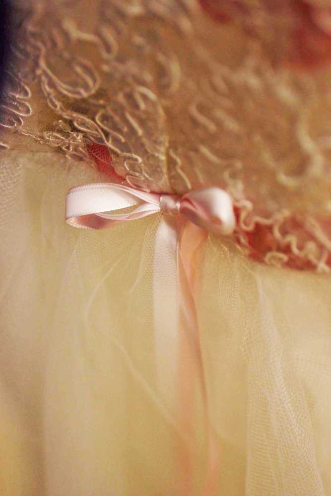 Photo by Kelly Sullivan/ Peninsula Clarion  Soldotna High School senior Emma Seldon and volunteer Maureen Mokracek examine a vintage-style dresss on Tuesday, March 18, at Cinderella's Closet.