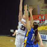 Nikolaevsk's Nianiella Dorvall (32) scores over Cook Inlet Academy's Nicole Moffis (11) during the 1A girls third-place game at the 2014 high school state basketball championships at Anchorage's Sullivan Arena on Wednesday.