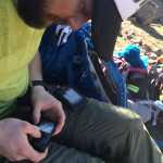 In a February 2014 photo provided by TwoSticksAndABoard.com, Sean Busby checks his insulin pump at base camp in the High Atlas Mountains near Marrakech, Morocco. By riding the highest mountain range in North Africa, Busby became the first person with Type 1 diabetes to snowboard on all seven continents. (AP Photo/TwoSticksAnd ABoard.com)