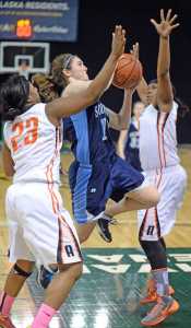 Soldotna's Julie Litchfield shoots against West's Marshal Eady (23) and Chamira Cockerham during their 4A girls state basketball tournament game on Thursday night at Anchorage's Sullivan Arena.