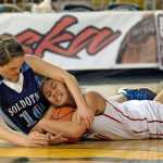 Soldotna High School senior Julie Litchfield (10) scraps for a loose ball with East sophomore Hannah Coffin during their 4A girls consolation bracket game in the ASAA state basketball tournament at Anchorage's Sullivan Arena on Friday.