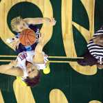Soldotna High School senior Katelynn Kerkvliet jumps center against East junior Taria Page during their 4A girls consolation bracket game in the ASAA state basketball tournament at Anchorage's Sullivan Arena on Friday.