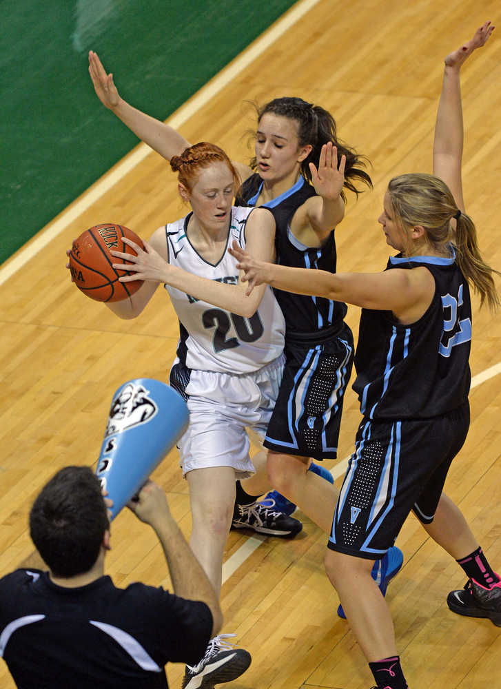 Nikiski sophomore Alison Litke (20) is defended by Valdez sophomores Madison Fleming, junior Veronica Hursh Rachel and a Buccaneers cheerleader during their 3A girls consolation bracket game in the ASAA state high school basketball tournament at Anchorage's Sullivan Arena on Friday.