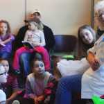 Photo by Kelly Sullivan/ Peninsula Clarion Girl Scout Volunteer Rosemary Pilatti evokes delighted gasps from her audience when she pulls out her sache full of patches from her years as a girl scout, Saturday March 22, at WSTD in Soldotna.