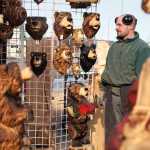 Photo by Rashah McChesney/Peninsula Clarion  Derrick Stanton watches a family browse through his temporary shop Tuesday March 25, 2014 on the Sterling Highway in Soldotna, Alaska. Stanton, whose permanent shop is based in Kenai, said he will be set up until Saturday in Soldotna.