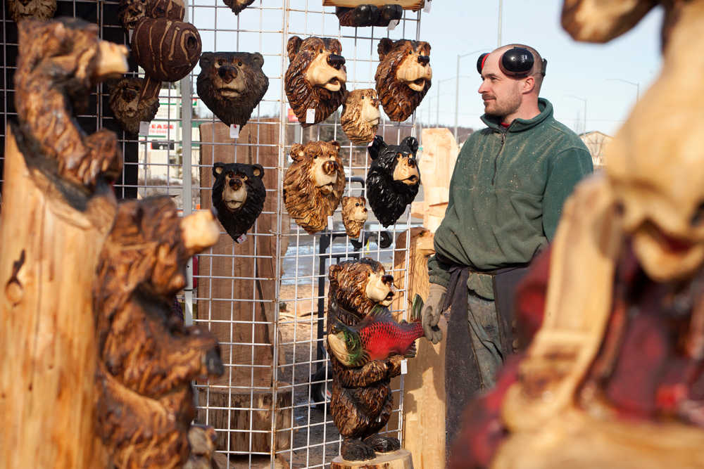Photo by Rashah McChesney/Peninsula Clarion  Derrick Stanton watches a family browse through his temporary shop Tuesday March 25, 2014 on the Sterling Highway in Soldotna, Alaska. Stanton, whose permanent shop is based in Kenai, said he will be set up until Saturday in Soldotna.
