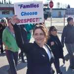 Photo by Rashah McChesney/Peninsula Clarion  Julie Quales watches traffic honking in support of the Alaskans Choose Respect walk Thursday March 27, 2014 in Kenai, Alaska.